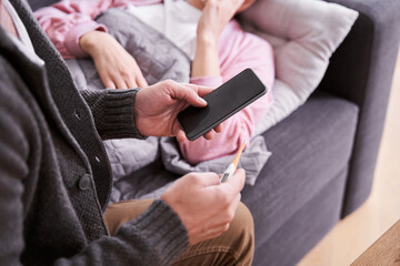 Fototapeta premium Man checking with thermometer fever temperature of his wife