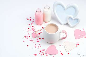 Delicate romantic composition for February 14 with a Cup of coffee, frame, hearts in white and pink flowers. The view from the top. Concept of holiday backgrounds.