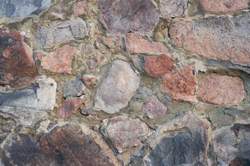 An ancient medieval wall of granite stones.