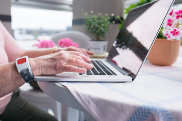 Senior woman using laptop, Sweden