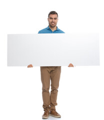 handsome casual man presenting his wide billboard