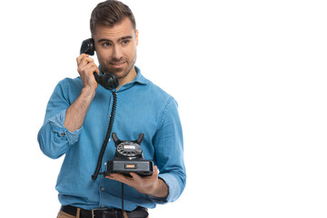 casual young man listening to someone on the telephone