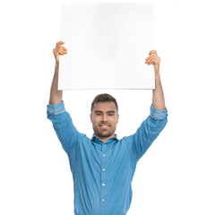 casual man showing a blank board at the camera