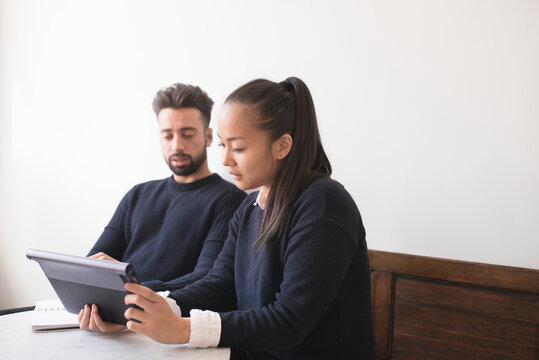 Couple in cafe using digital tablet, Sweden