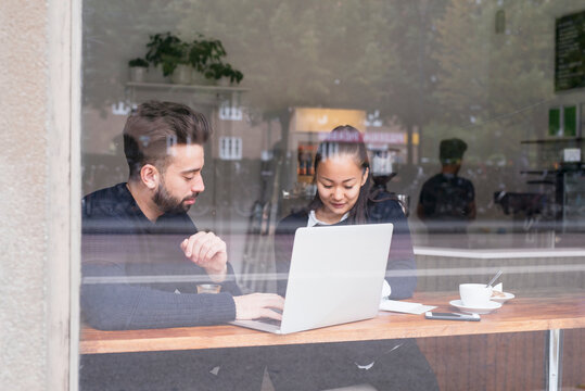 Couple in cafe using laptop, Sweden