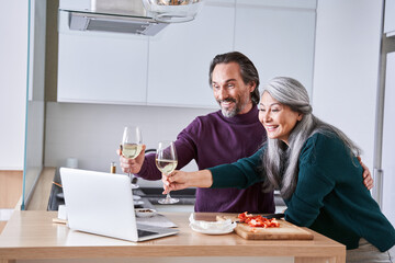 Couple pulling glasses to the screen