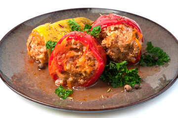 Slightly broken off with a fork stuffed pepper with herbs and spices on a white platter. The view from the top. Concept of culinary backgrounds.