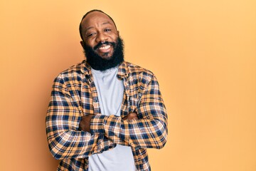 Young african american man wearing casual clothes happy face smiling with crossed arms looking at the camera. positive person.