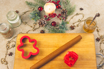 Traditional Christmas ginger cookies. Step-by-step recipe. Jars of spices, a baking dish, a Board and a candle with Christmas decor. The view from the top. Horizontal cropping. Selective focus