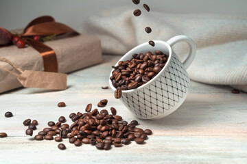 Pouring coffee beans into a flying Cup on a festive background. Side view. Concept of coffee backgrounds.