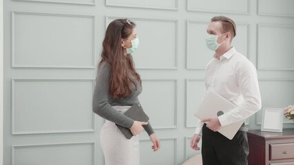 Young american business man and woman in face mask greeting with elbow bump at office, new normal, businessman and businesswoman meeting and discuss, social distancing, communication concept.