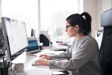Businesswoman sitting in office, Sweden
