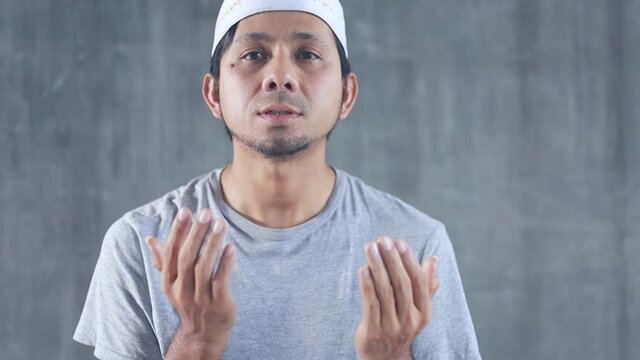 Young asian muslim man praying