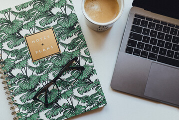 Notebook, laptop and coffee on desk, Finland