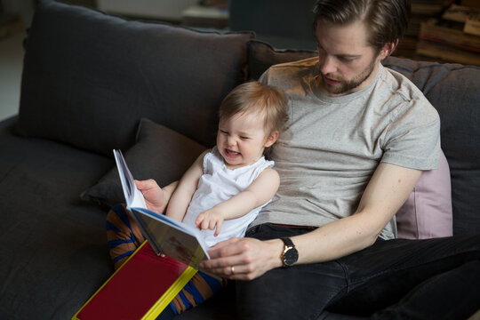 Father reading with son, Sweden