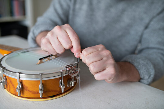Man changing mandolin string, Sweden
