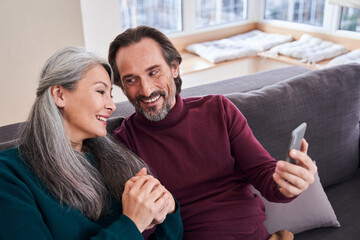 Couple resting on couch in living room