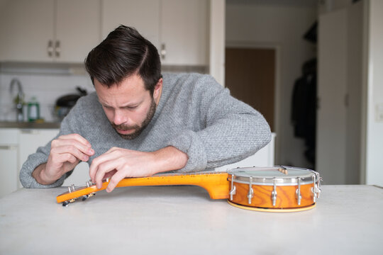 Man changing mandolin string, Sweden