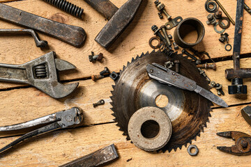 Variety of old vintage household hand tools still life on a wooden background in a DIY and repair concept