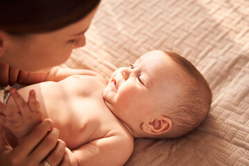 Mom and baby playing in bedroom