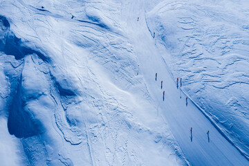 Drone image of mountains in winter. Image with snow, texture and shadows. 