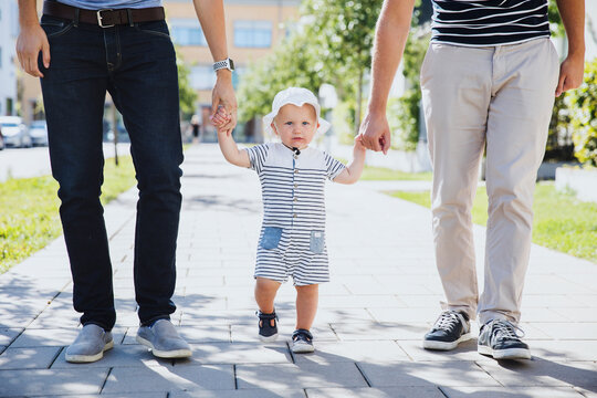 Toddler boy walking with fathers, Sweden