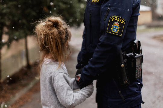 Police woman hugging daughter, Sweden