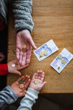Hands holding coins, Sweden