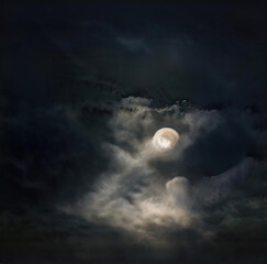 Obraz na płótnie Canvas Moon in cloudy, stormy sky at night
