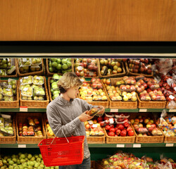Young man buying vegetables  and fruits at the market