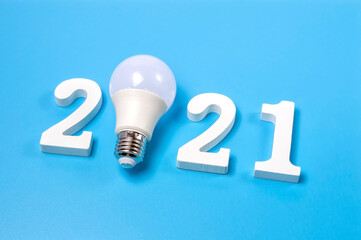 Concept of ideas for creativity and inspiration 2021 with light bulb on blue background