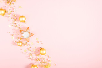 Christmas gold holiday composition. Xmas golden decorations on pink background. Christmas, New Year, winter concept. Flat lay, top view, copy space