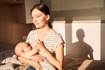 Fototapeta na wymiar Mother breastfeeding her little newborn