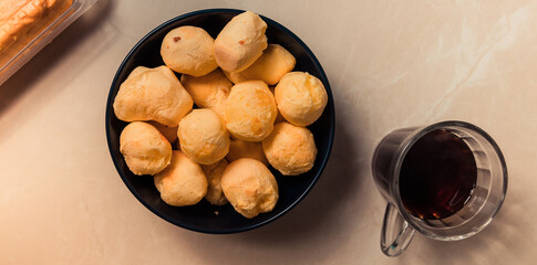Homemade cheese buns, rustic style, vintage wooden background, top view. typical food from minas gerais Brazil.