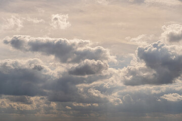 Fototapeta na wymiar sky full of clouds and sunbeams shining through