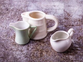 Three portion jugs for cream or milk on the table