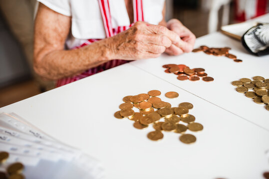 Woman counting coins, Sweden