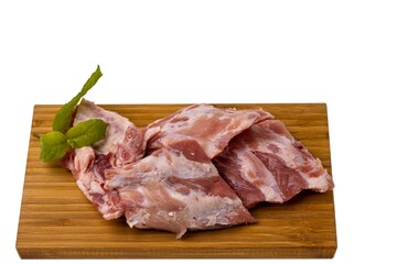 View of raw pork ribs on wooden cutting broad. Cooking and food concept.