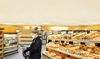 Woman choosing bread  from a supermarket,face mask and gloves,
