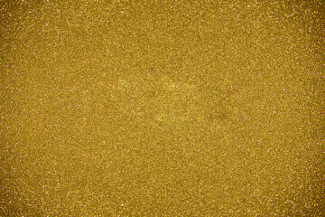 Glitter dark yellow background. Photo of monotone shiny background.