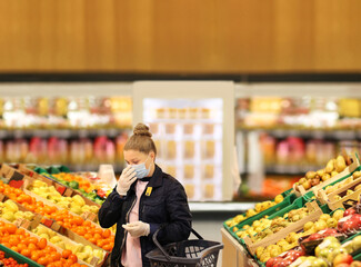 Supermarket shopping, face mask and gloves,woman buying vegetables at the market