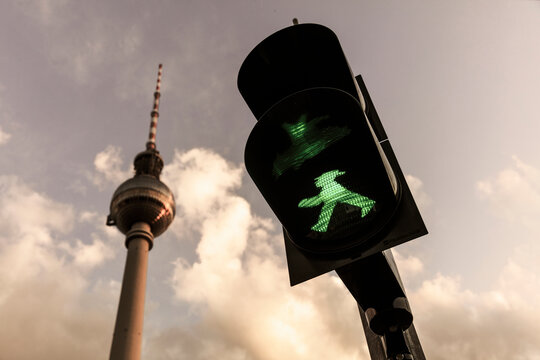 Green Ampelmann (Ampelmännchen) on Berlin Traffic Light with Berlin TV Tower in background (Berliner Fernsehturm) August 14th 2017, Berlin, Germany