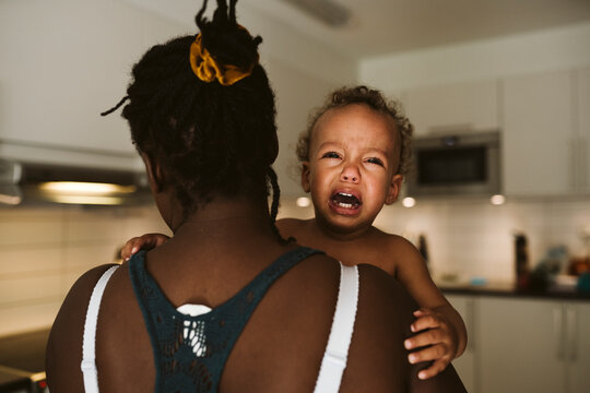 Mother carry crying toddler, Sweden