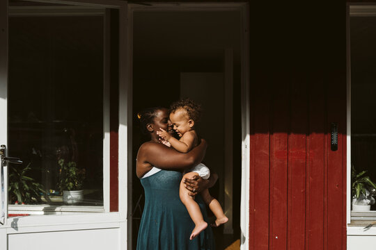 Mother with toddler in front of house, Sweden