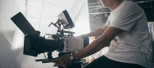 Professional film and video camera on the set. Shooting shift, equipment and group.