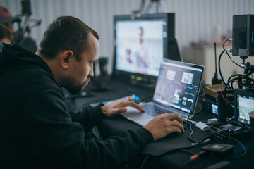 Editing director behind monitors on the set.