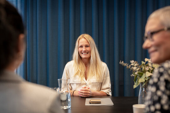 Smiling woman at business meeting, Sweden