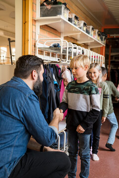 Teacher greeting children, Sweden
