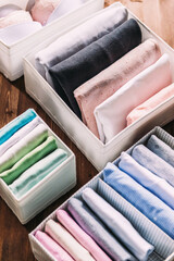 Perfectly folded clothes into home storage boxes, organizing space