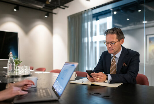 Mature businessman using cell phone, Sweden